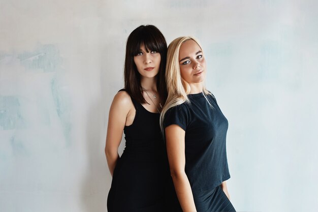 Women posing on wall