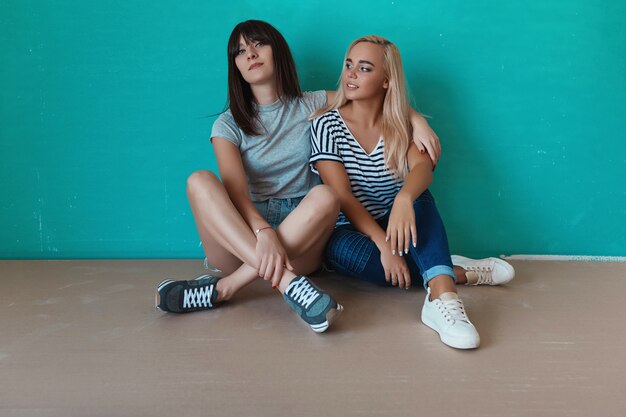 Women posing on wall