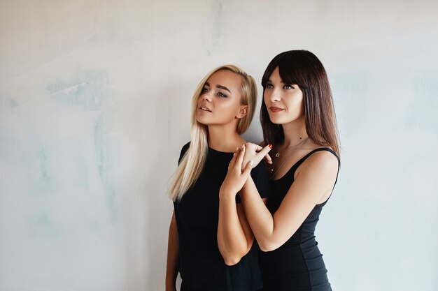 Women posing on wall