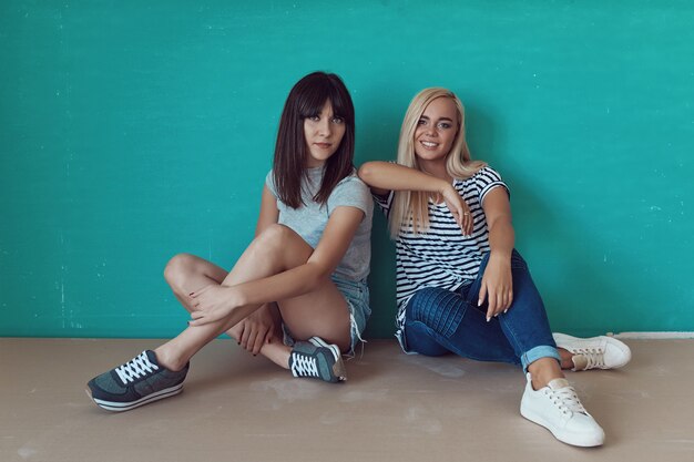 Women posing on wall