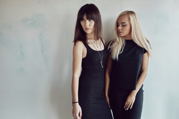 Women posing on wall