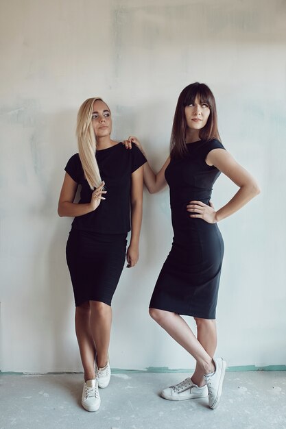 Women posing on wall