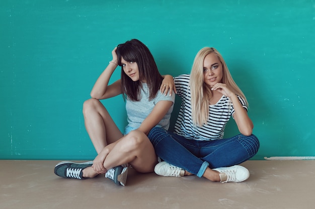 Free photo women posing on wall