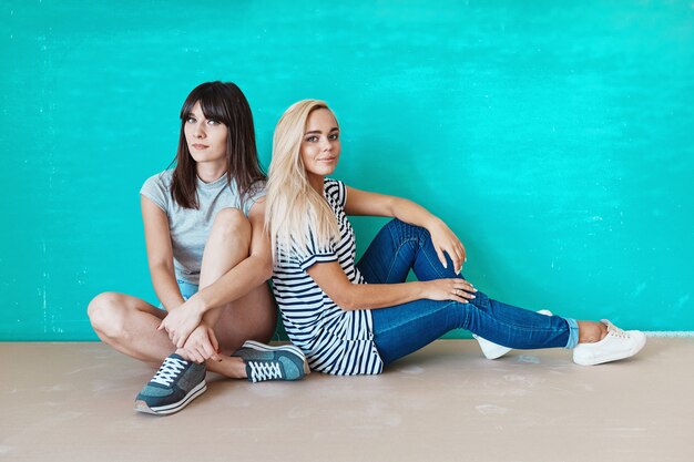 Women posing on wall