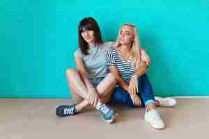 Free photo women posing on wall