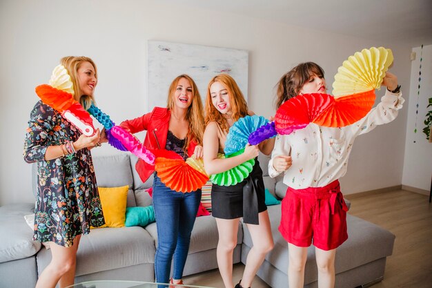 Women posing with paper decoration