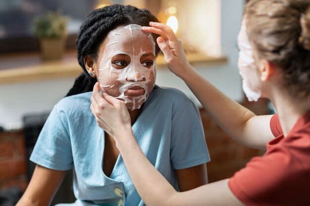 Women practicing skincare at home