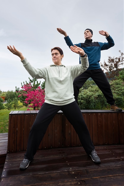 Women practicing tai chi full shot