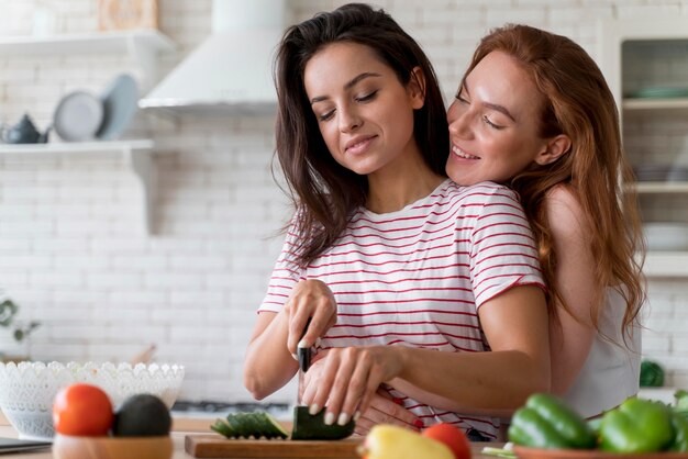 Women preparing together a romantic dinner at home