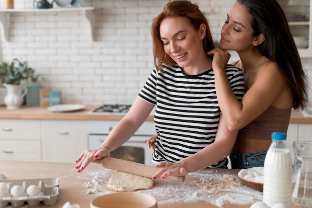 Women preparing together a romantic dinner at home