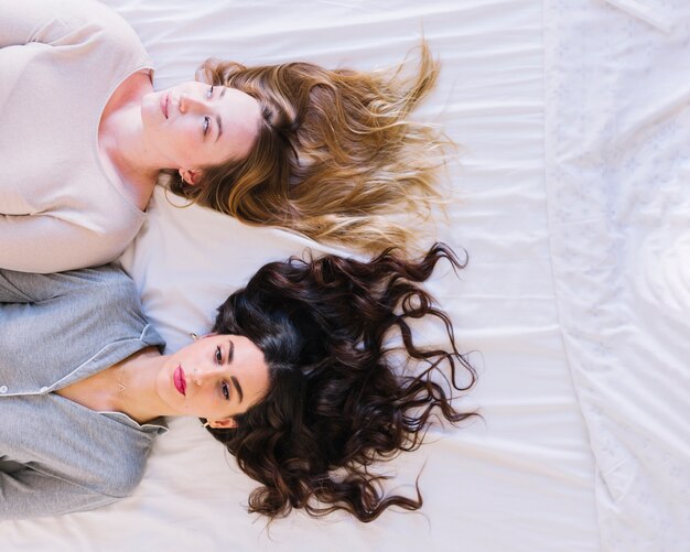 Women resting on white sheet