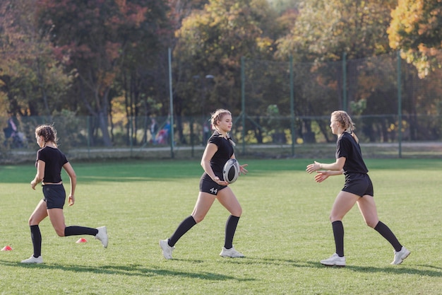 Women running on a football pitch