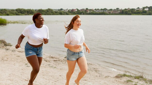 Women running together at the beach