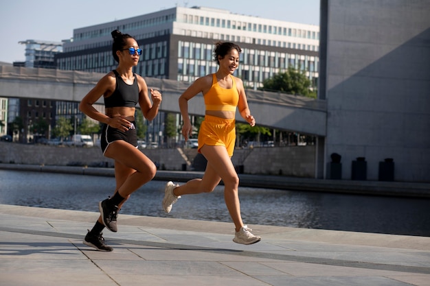 Women running together full shot