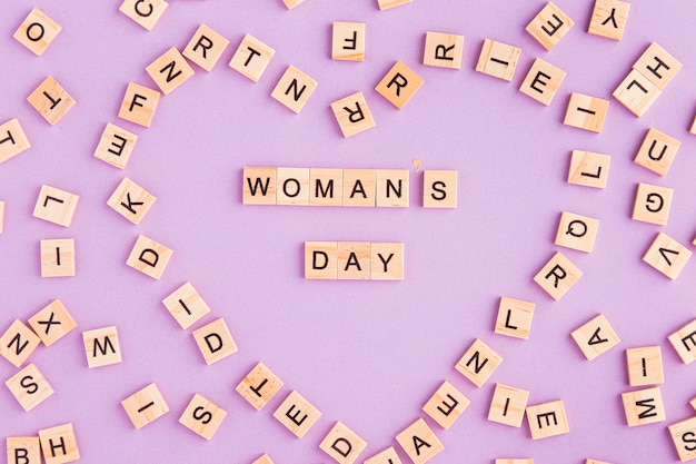 Free photo women's day written in scrabble letters forming a heart shape