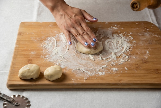 Women's hands make dough for Azerbaijani dish gutab. 