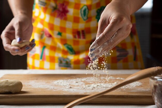 Women's hands make dough for Azerbaijani dish gutab. 