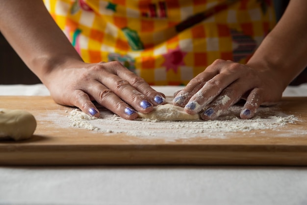 Women's hands make dough for Azerbaijani dish gutab. 