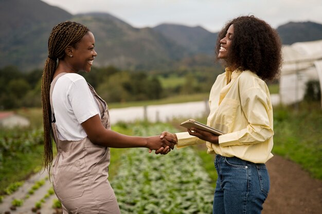 Women shaking hands side view