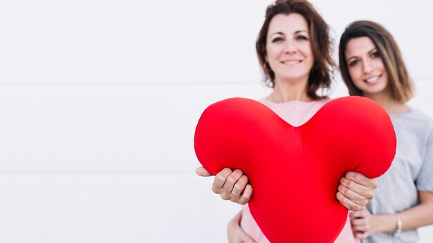 Women showing plush heart