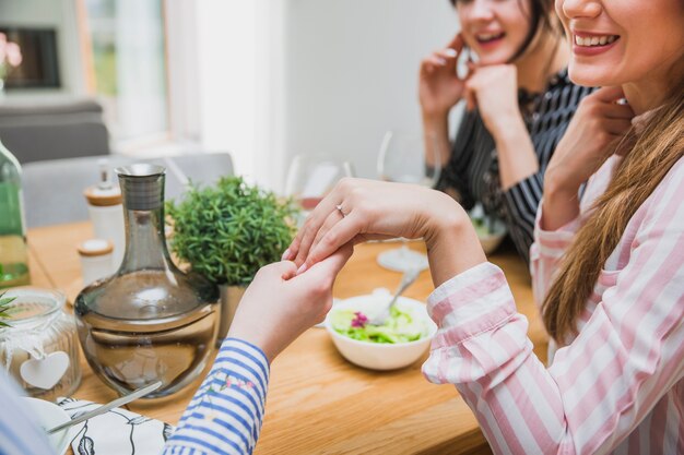 Women showing ring to friends