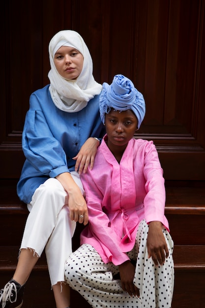 Free photo women sitting on stairs front view