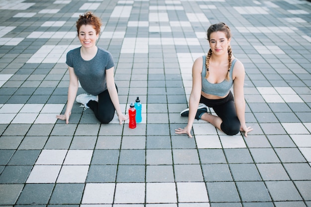 Women sitting and stretching while training