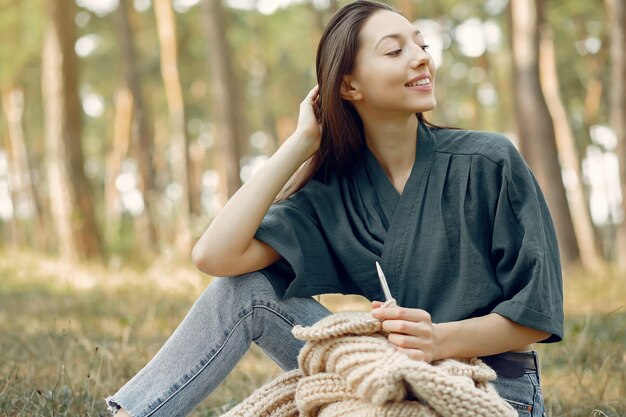 Free Photo women sitting in a summer park and knitting