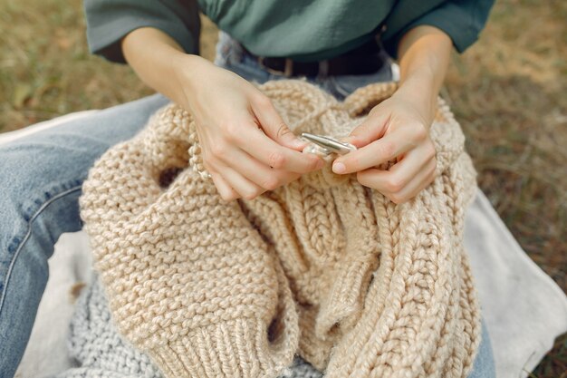 women sitting in a summer park and knitting