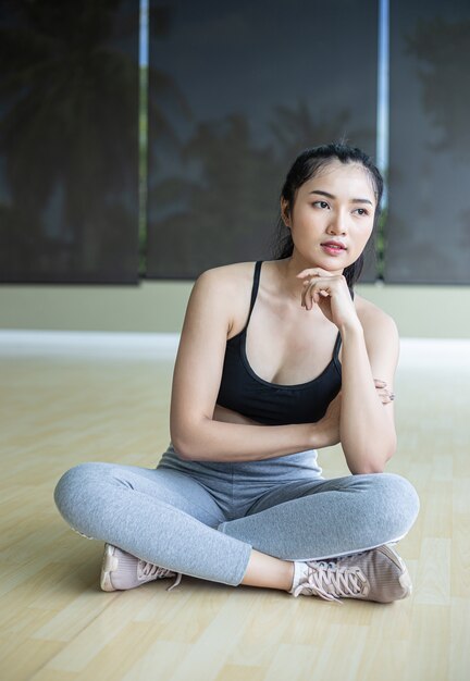 Women sitting wearing exercise clothes and chin on their hands