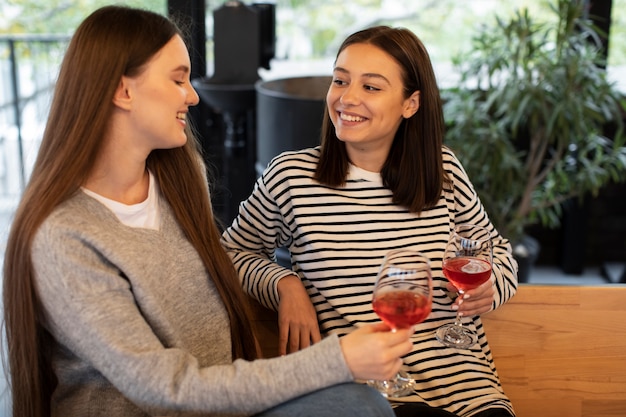 Women smiling and holding glasses of wine