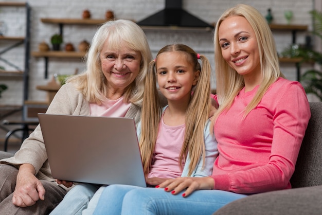 Women smiling and sitting on couch in living room