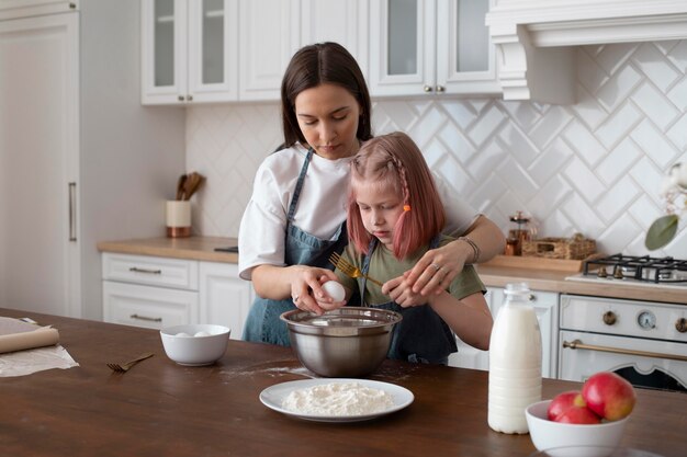 Free photo women spending time together with their daughter at home