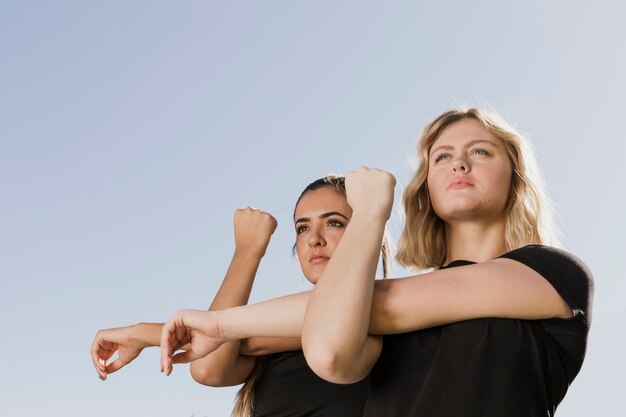 Women stretching outdoors low angle view