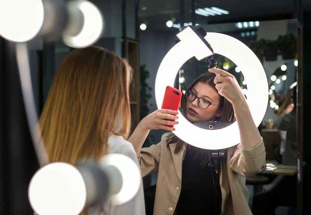 Free photo women taking photos using rim light