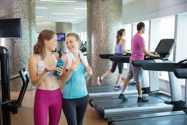 Women talking next to treadmills