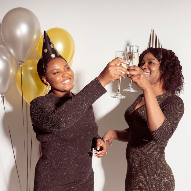 Women toasting glasses of champagne happy birthday party