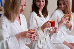 Free photo women trying healthy drinks at spa