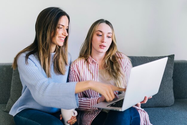 Women using laptop together