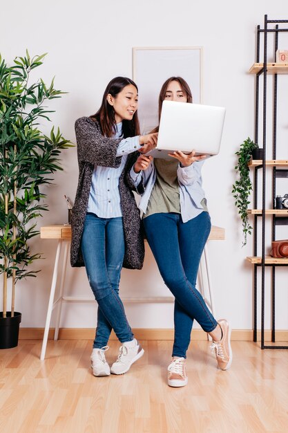 Women using laptop while coworking