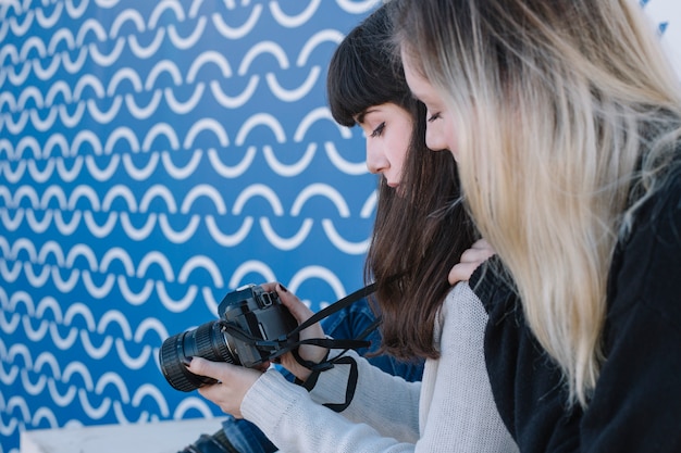 Women using photo camera outside