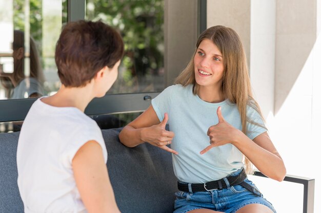 Women using sign language to communicate with each other