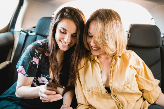 Women using smartphone in car