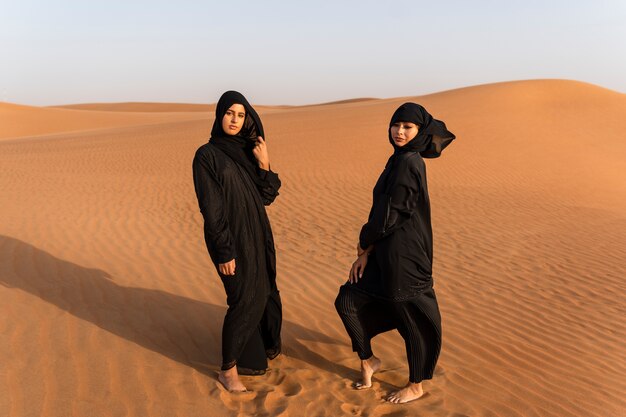 women wearing hijab in the desert