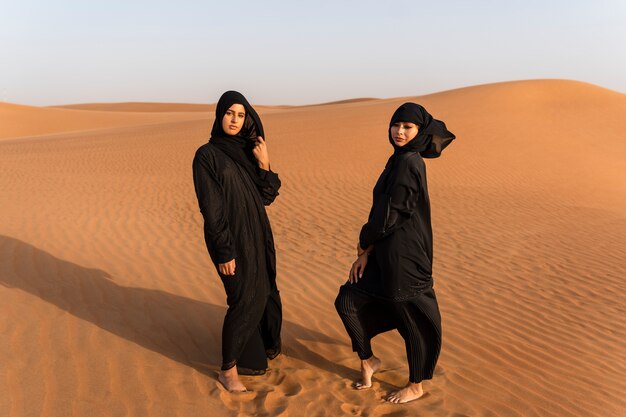 Women wearing hijab in the desert