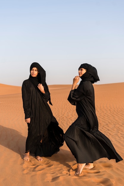 women wearing hijab in the desert