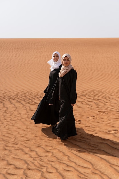 women wearing hijab in the desert