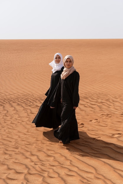 Women wearing hijab in the desert