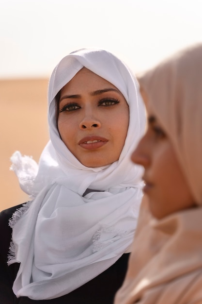 Free photo women wearing hijab in the desert