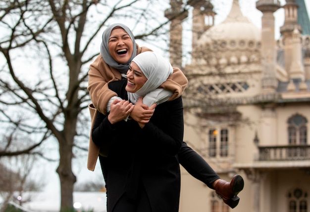 Free photo women wearing hijab an having a good time